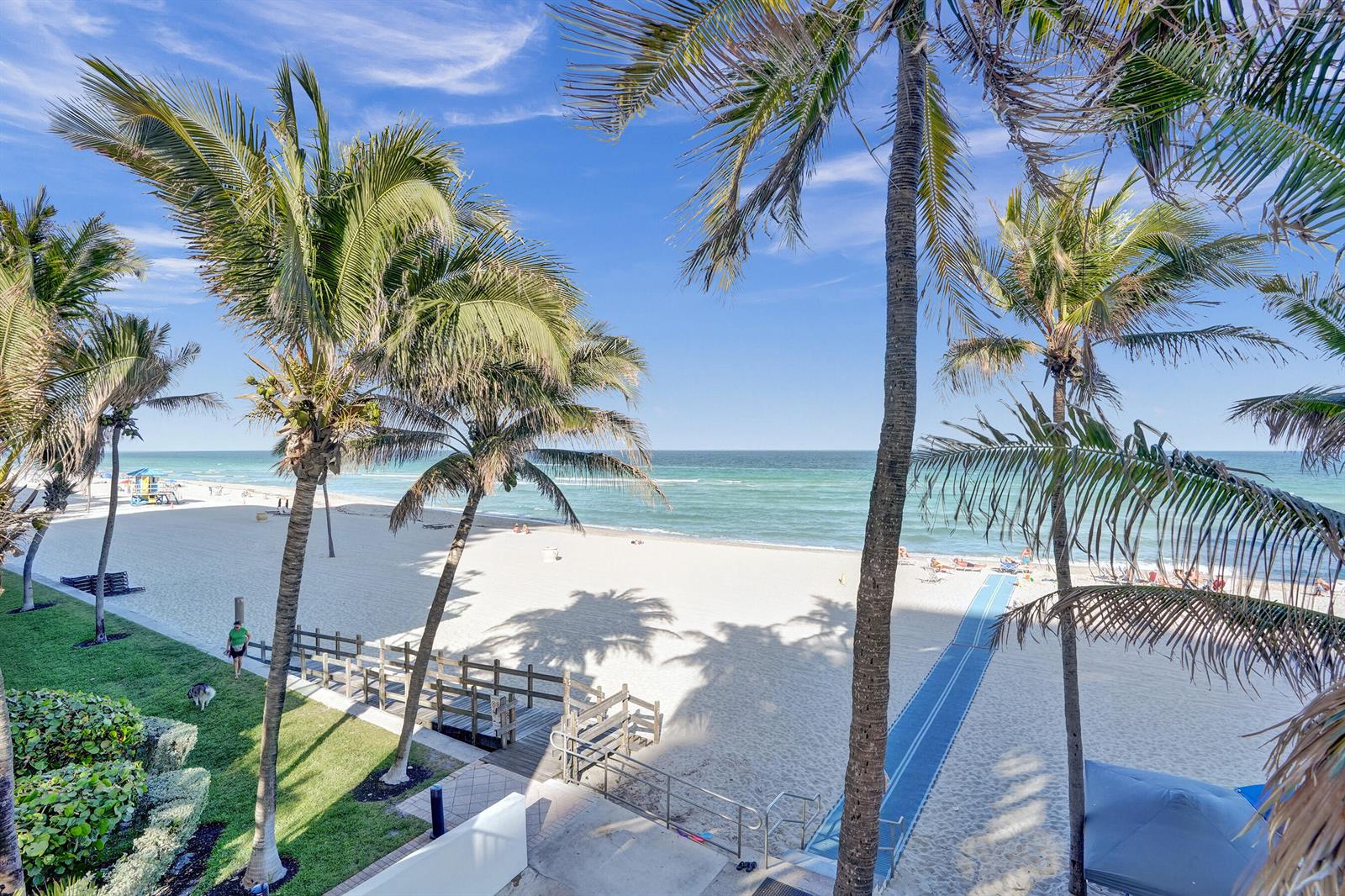 An elevated view of a sandy beach with palm trees, a wooden walkway, and ocean — 2301 S Ocean Drive # 1408, Hollywood FL 33019, HOLLYWOOD, FL