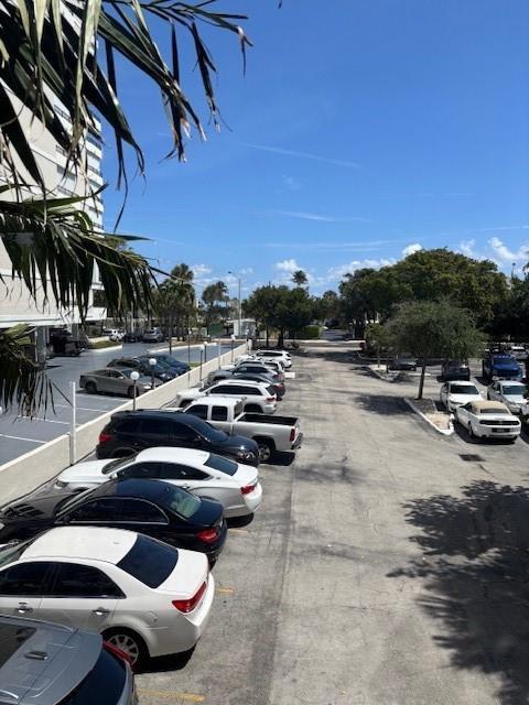 An elevated view shows a parking lot with several cars parked in rows near buildings — 1421 S Ocean Boulevard # 218, Pompano Beach FL 33062, POMPANO BEACH, FL