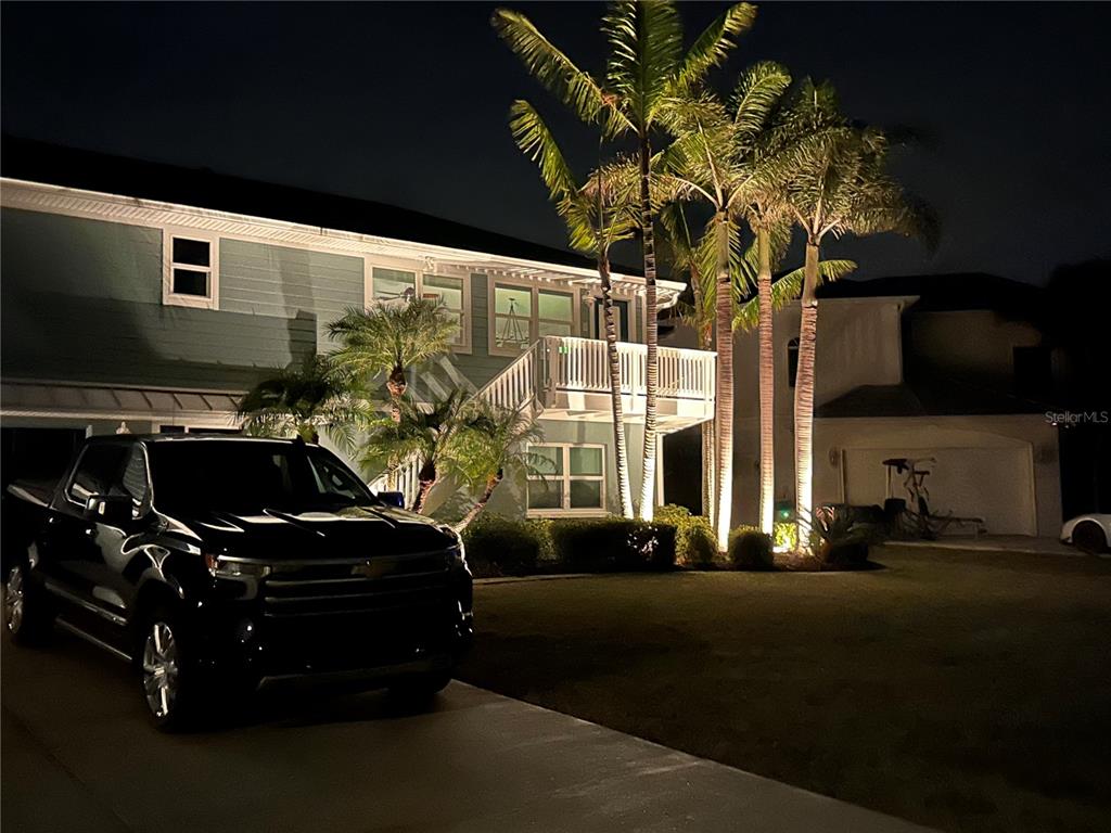 A black pickup truck is parked in the driveway of a two-story house at night — 4255 SPIRE STREET, PORT CHARLOTTE, FL