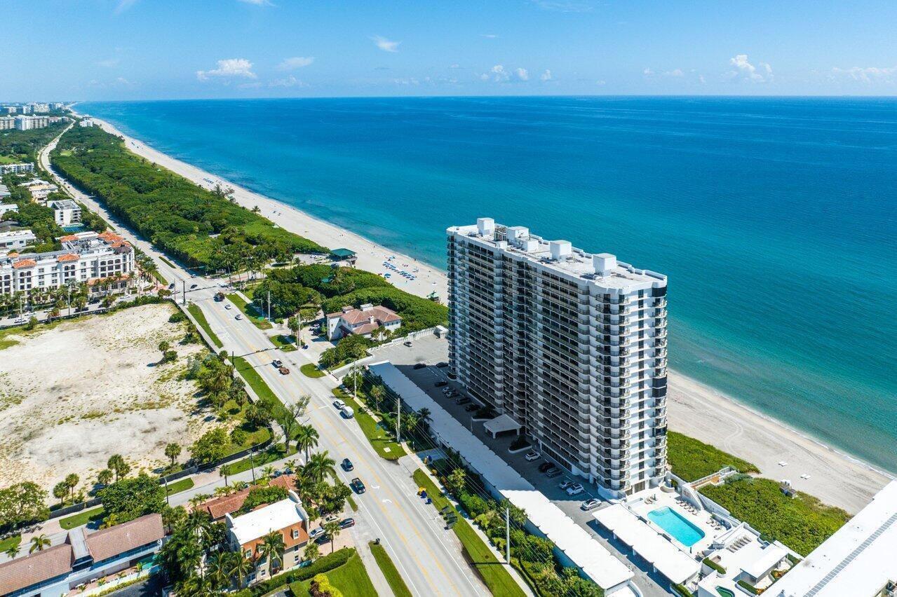 An aerial view of a tall beachfront condominium building next to a coastal road — 250 S Ocean Boulevard # 6f, Boca Raton FL 33432, BOCA RATON, FL