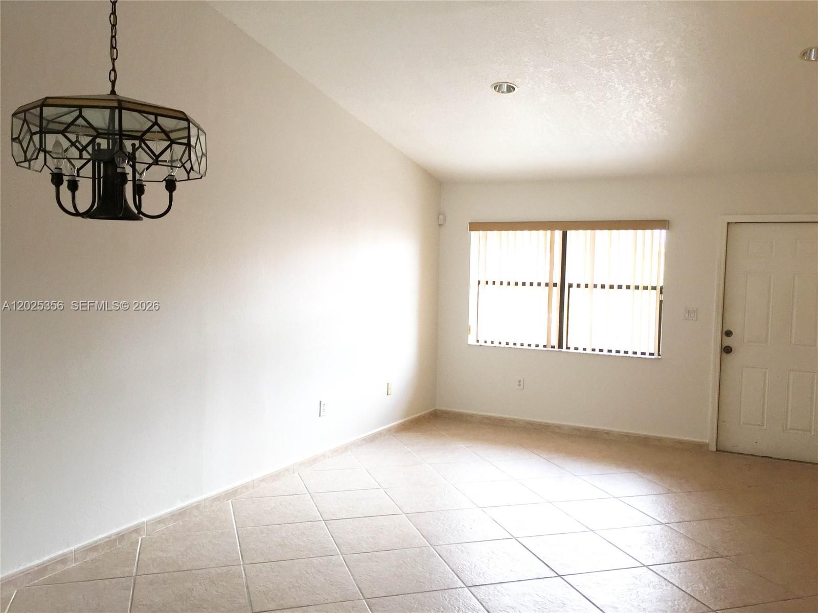 A single-story residential building with a white front door and palm trees in front — 15570 SW 76th Ln # 9, Miami FL 33193, MIAMI, FL