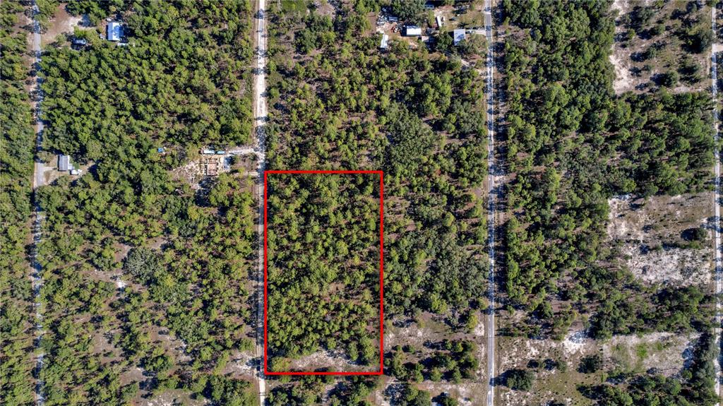 An aerial view shows a rectangular plot of wooded land outlined in red — LOTS 16 AND 17 SE 130TH CT, DUNNELLON, FL
