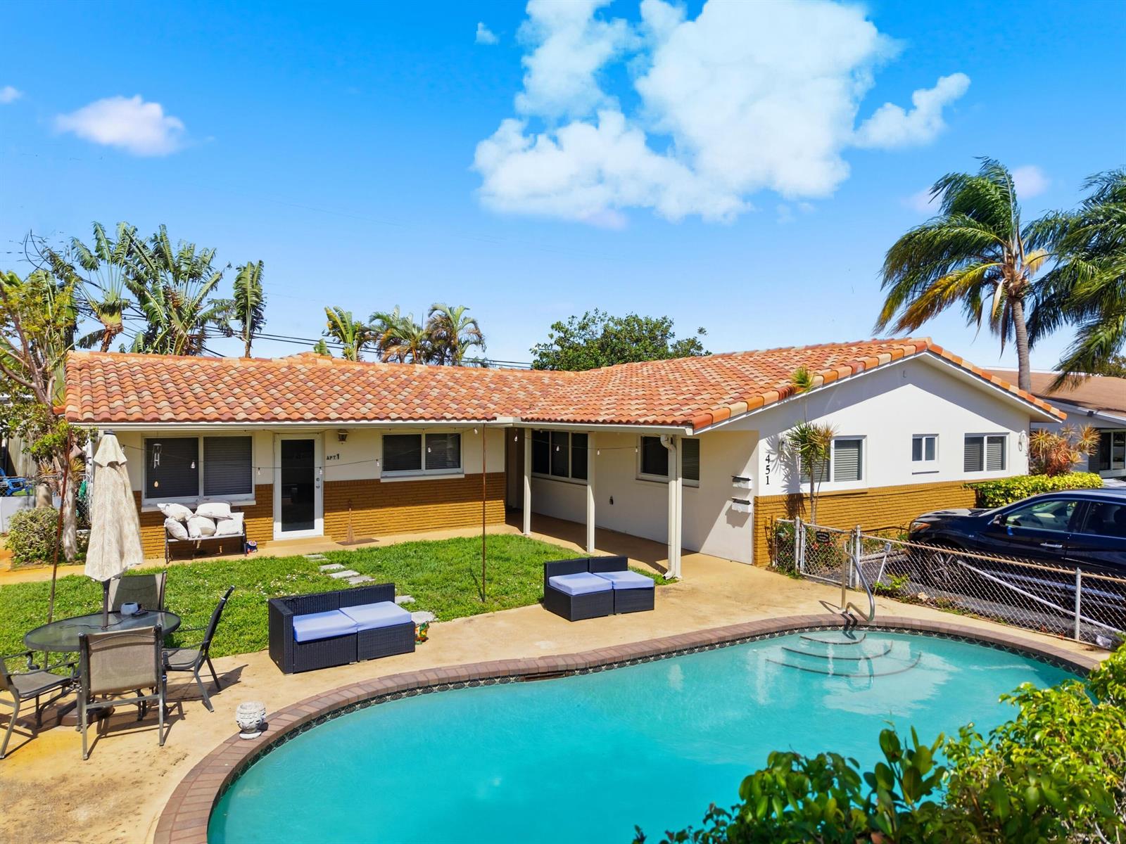 A single-story house with a tiled roof, a swimming pool, and outdoor seating areas — 451 SE 1st Avenue # B, Pompano Beach FL 33060, POMPANO BEACH, FL