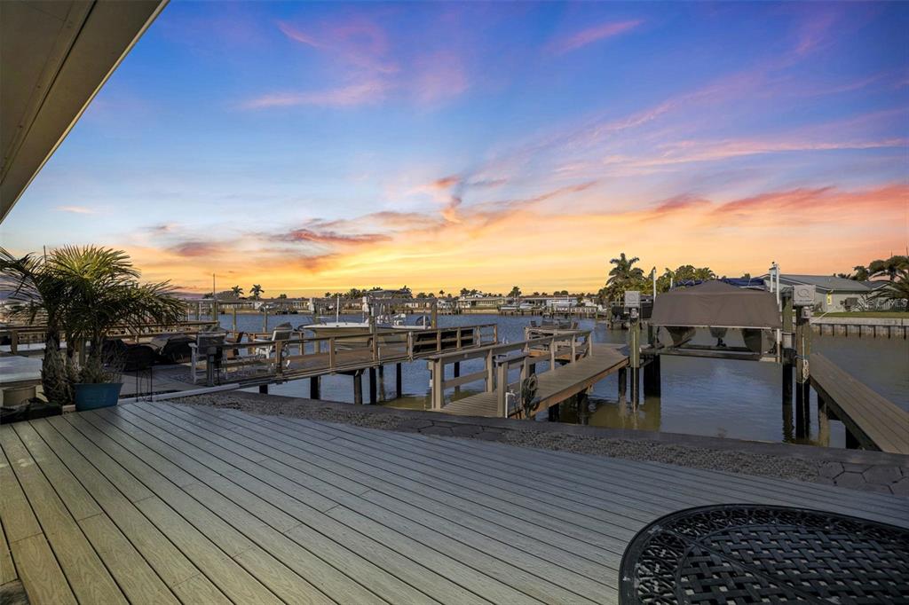 A kitchen with white cabinets, granite countertops, stainless steel appliances, and a patterned area rug — 403 BOCA CIEGA POINT BOULEVARD N, ST PETERSBURG, FL