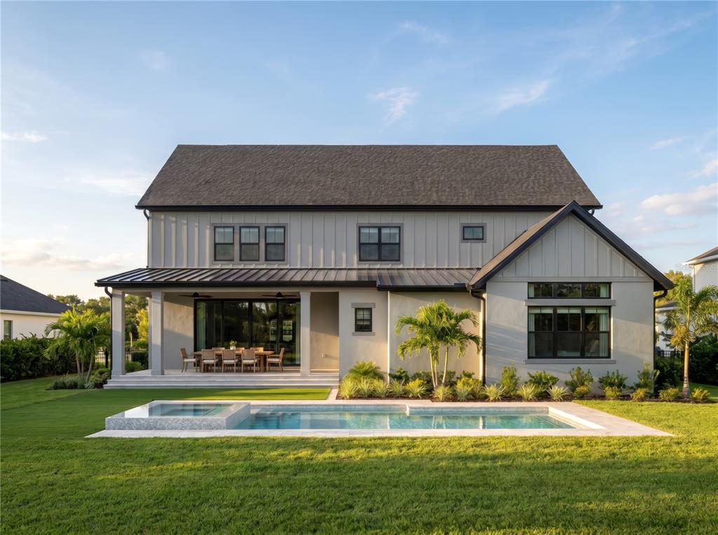 A two-story house with vertical siding, a covered patio, and a rectangular swimming pool — 1152 PRADO LANE, WINTER GARDEN, FL