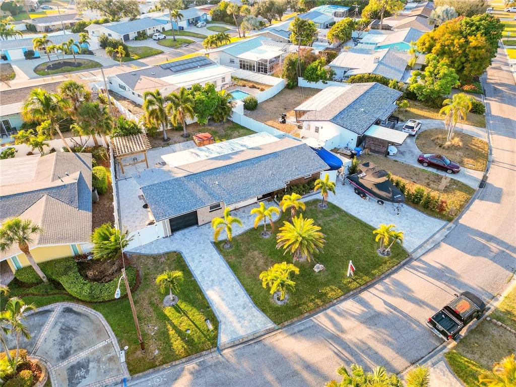 An aerial view shows a single-story house with a paved driveway, lawn, and palm trees — 5235 40TH STREET S, ST PETERSBURG, FL