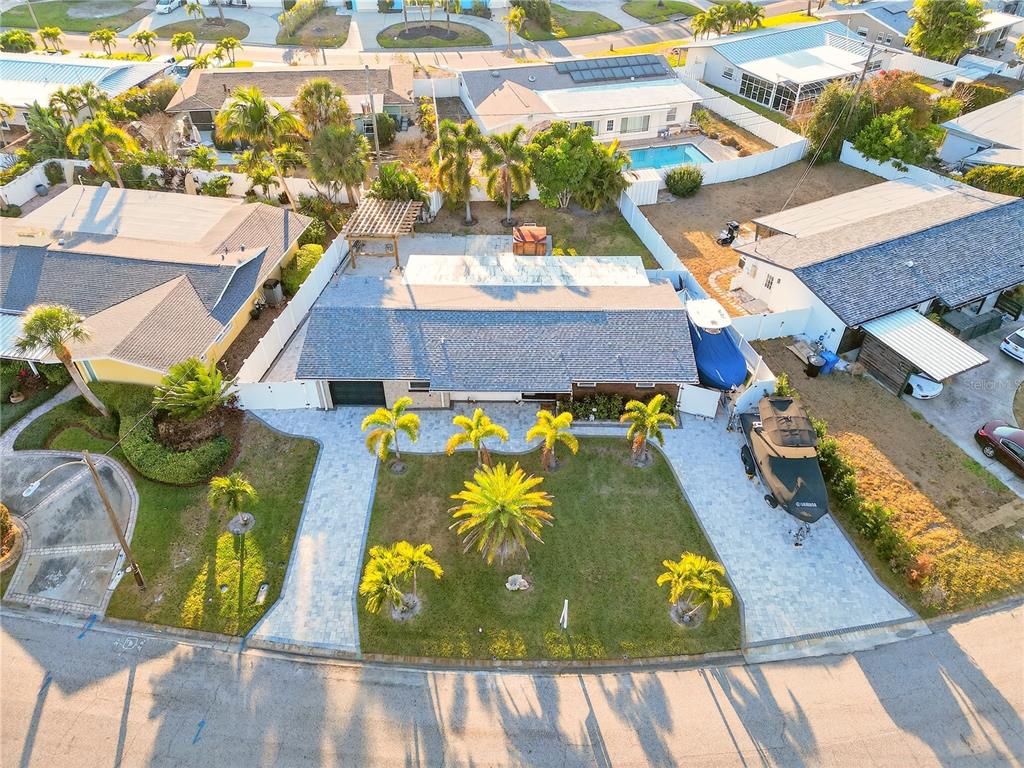 An aerial view of a single-story house with a paved driveway, boat, and palm trees — 5235 40TH STREET S, ST PETERSBURG, FL