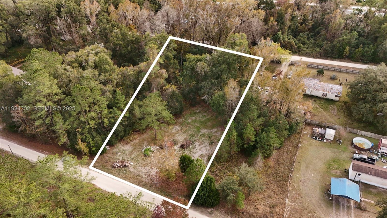 An aerial view shows a rectangular, partially cleared lot surrounded by dense trees and vegetation — 0 Southwest 2nd Place, Ocala FL 34476, OCALA, FL