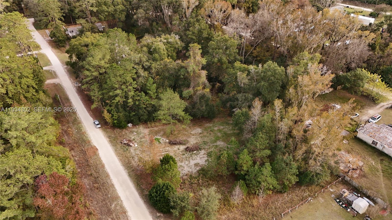 An aerial view shows a vacant, wooded lot bordered by a dirt road — 0 Southwest 2nd Place, Ocala FL 34476, OCALA, FL