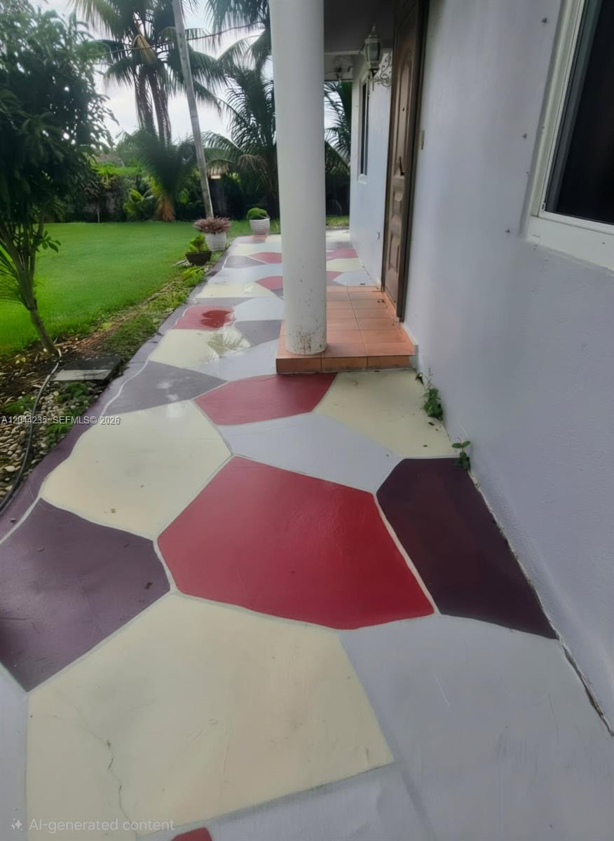 A covered outdoor walkway features a painted, multi-colored geometric pattern on the concrete floor — 19550 SW 162nd Ave, Miami FL 33187, MIAMI, FL