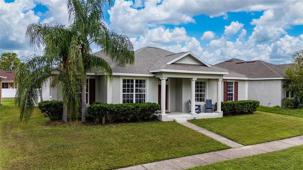 A single-story suburban house with a palm tree, a covered porch, and a grassy lawn — 3108 WESTBROOK ROAD, KISSIMMEE, FL