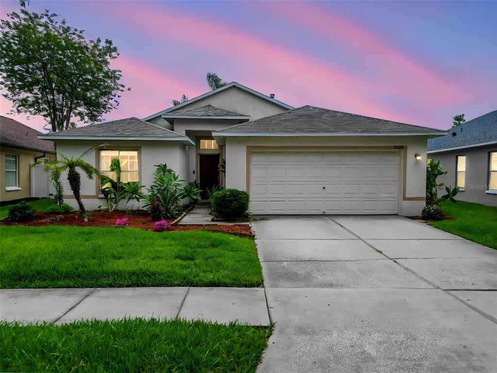 A single-story suburban house with a two-car garage and a landscaped front yard — 2003 BERRY LAKE DRIVE, BRANDON, FL