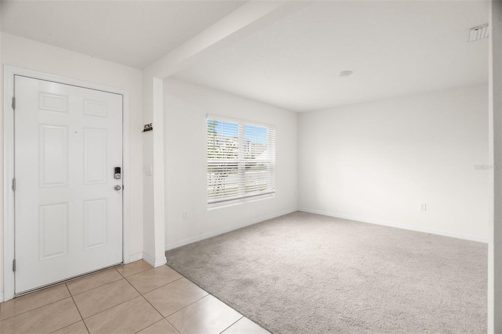 A kitchen features dark wood cabinets, granite countertops, stainless steel appliances, and an island sink — 2818 GUMBO LIMBO DRIVE, WIMAUMA, FL