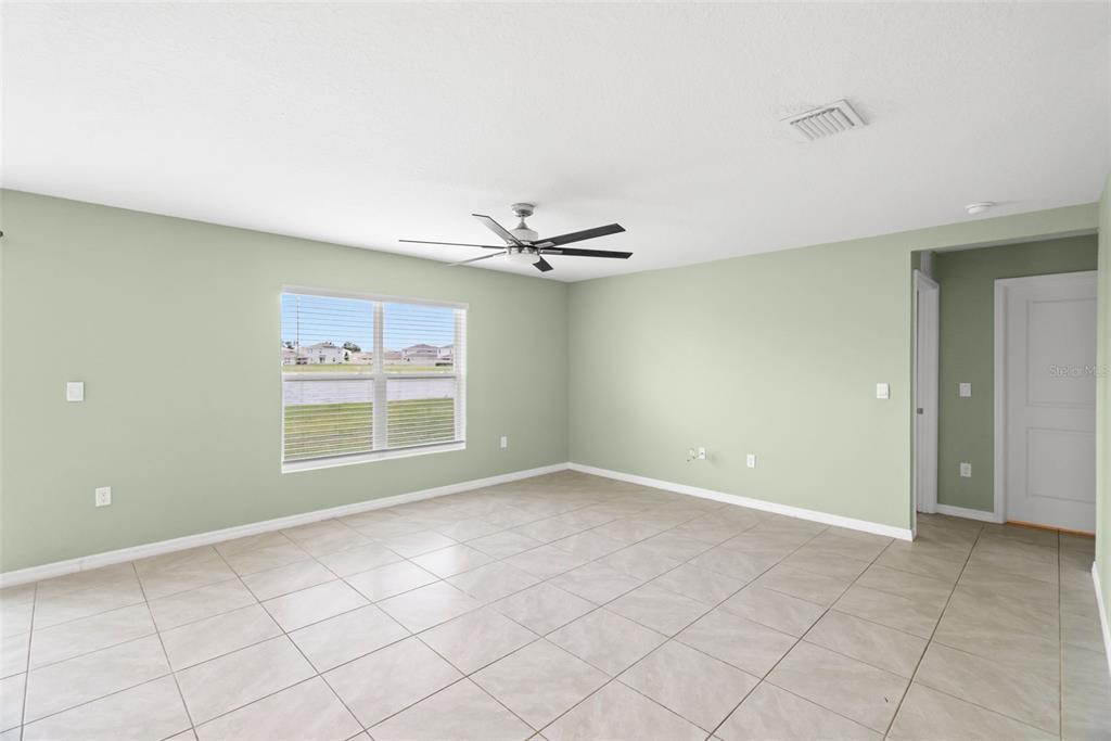 A bathroom features a vanity with a sink, a walk-in shower, and a separate toilet — 2818 GUMBO LIMBO DRIVE, WIMAUMA, FL