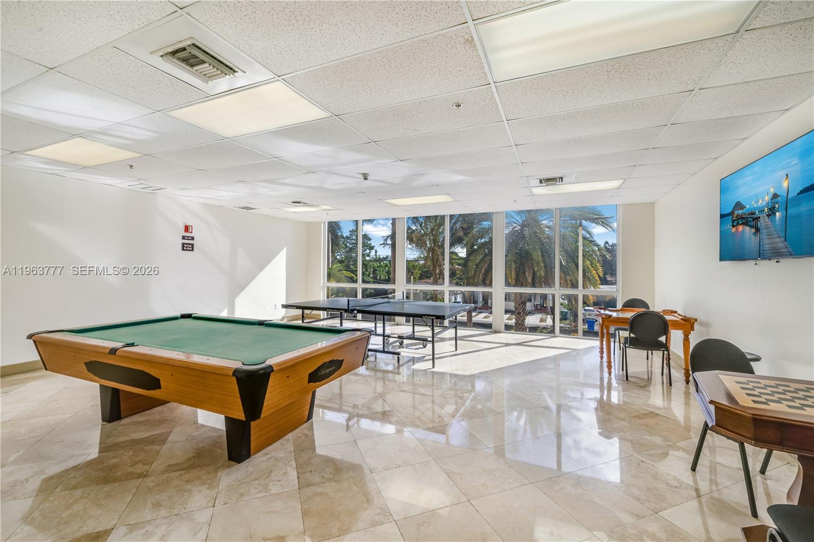 A game room features a pool table, ping pong table, card table, and tile flooring — 3500 Coral Way # 1207, Miami FL 33145, MIAMI, FL