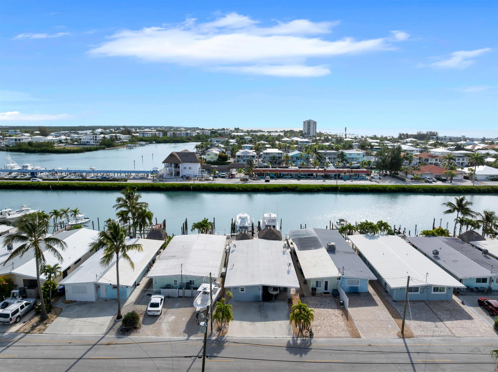 An aerial view shows a row of waterfront houses with private docks along a canal — 34 7th Street, FL 33051, FL