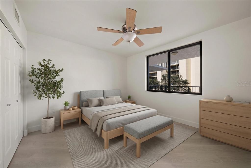 A bedroom features a bed, a bench, a chair, and a sliding door to a balcony — 670 ISLAND WAY UNIT 304, CLEARWATER BEACH, FL