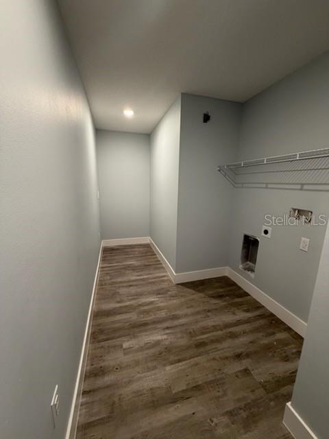 A laundry room with light blue walls, wood-look flooring, and a wire shelving unit — 521 SKYLINE DRIVE E, LAKELAND, FL