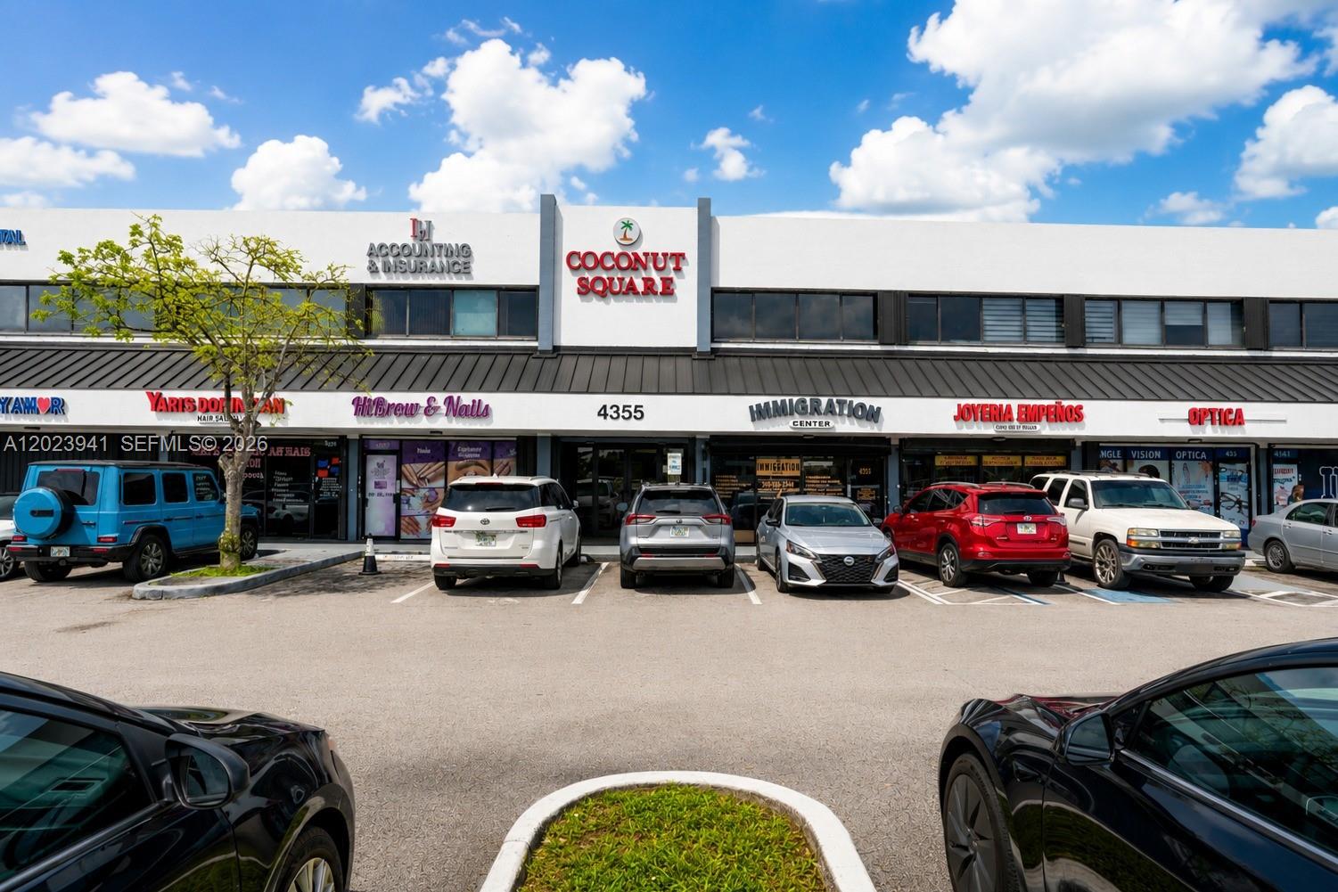 A two-story commercial strip mall with multiple storefronts and a parking lot in front — 4355 W 16th Ave # 211, Hialeah FL 33012, HIALEAH, FL
