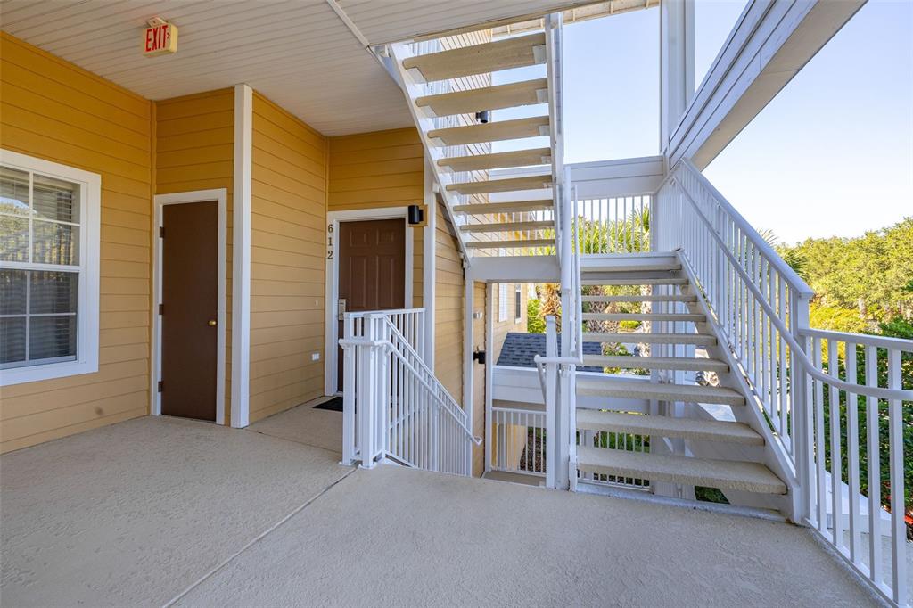 An outdoor landing features a brown door numbered 612 and white metal stairs — 612 RUM RUN UNIT 612, DAVENPORT, FL