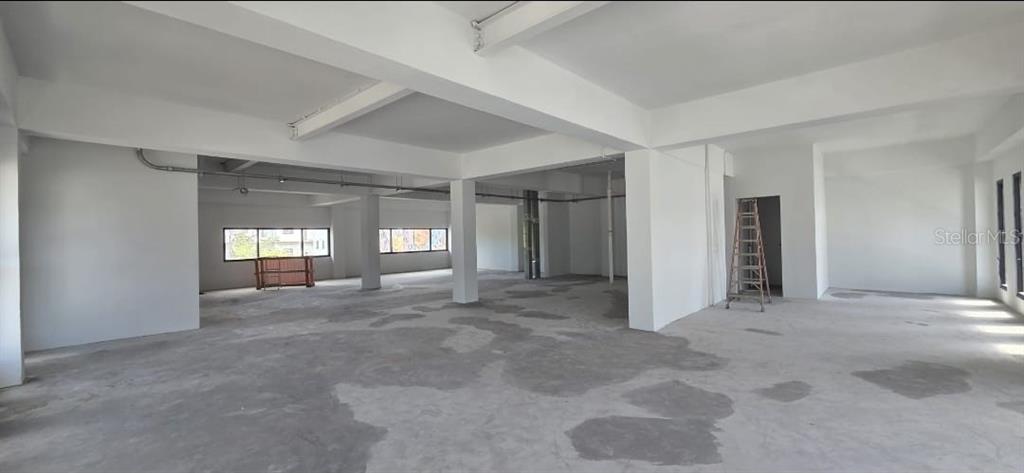 An unfinished, open-concept commercial space features white walls, concrete floors, and exposed ceiling beams — 656 RH TODD UNIT 3, SAN JUAN, PR