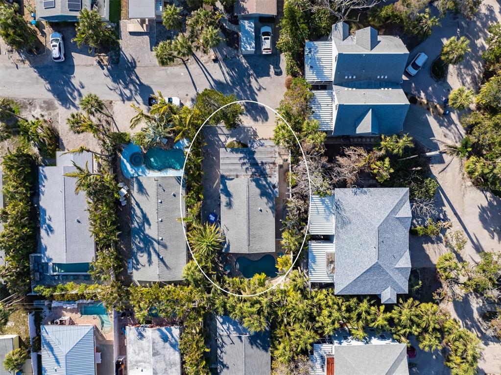 Aerial view of a residential property featuring a house with a pool and palm trees — 5807 DE PALMAS AVENUE, HOLMES BEACH, FL