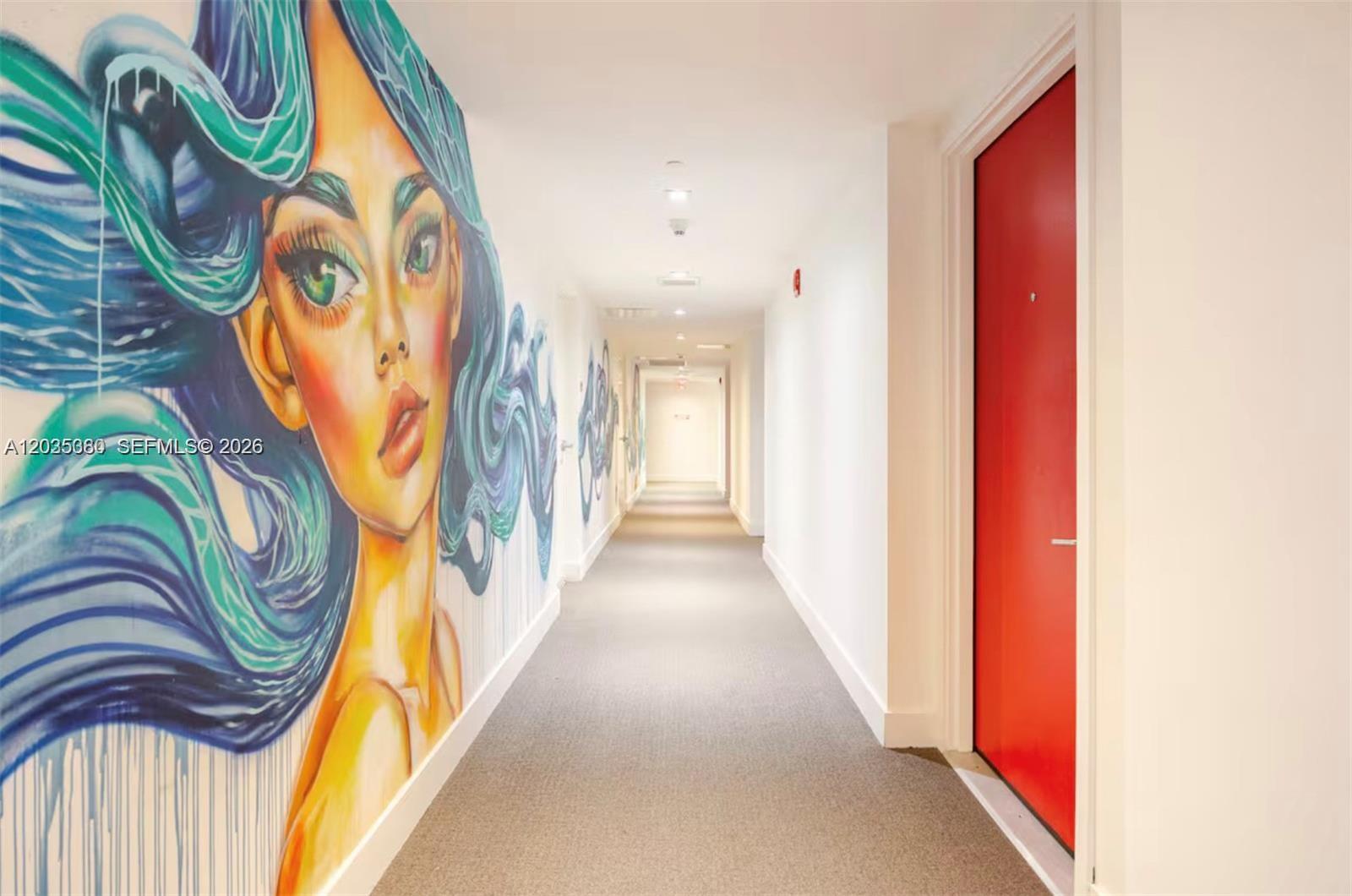 A hallway features a large mural of a woman with blue hair and a red door — 1600 NE 1 AVE # 3519, Miami FL 33132, MIAMI, FL