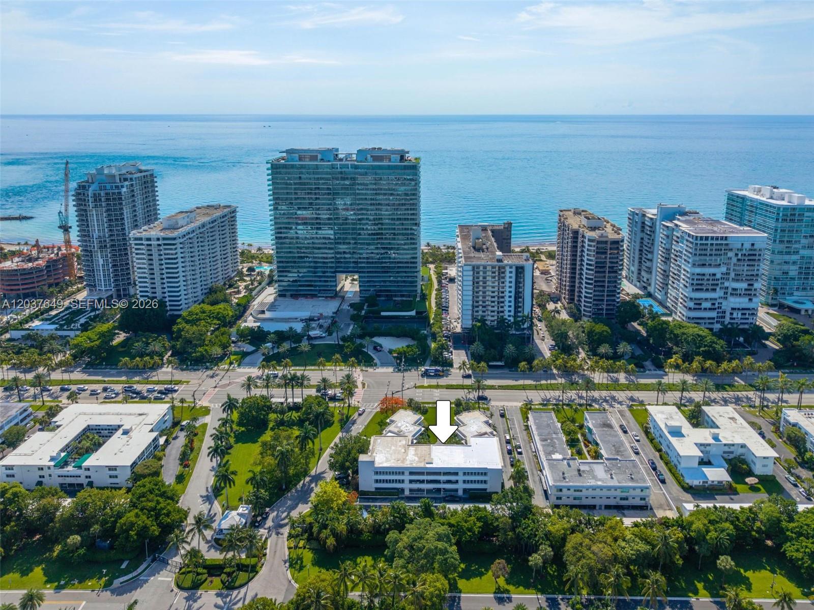 An aerial view shows a low-rise apartment building marked by an arrow near the ocean — 10190 Collins Ave # 107, Bal Harbour FL 33154, BAL HARBOUR, FL