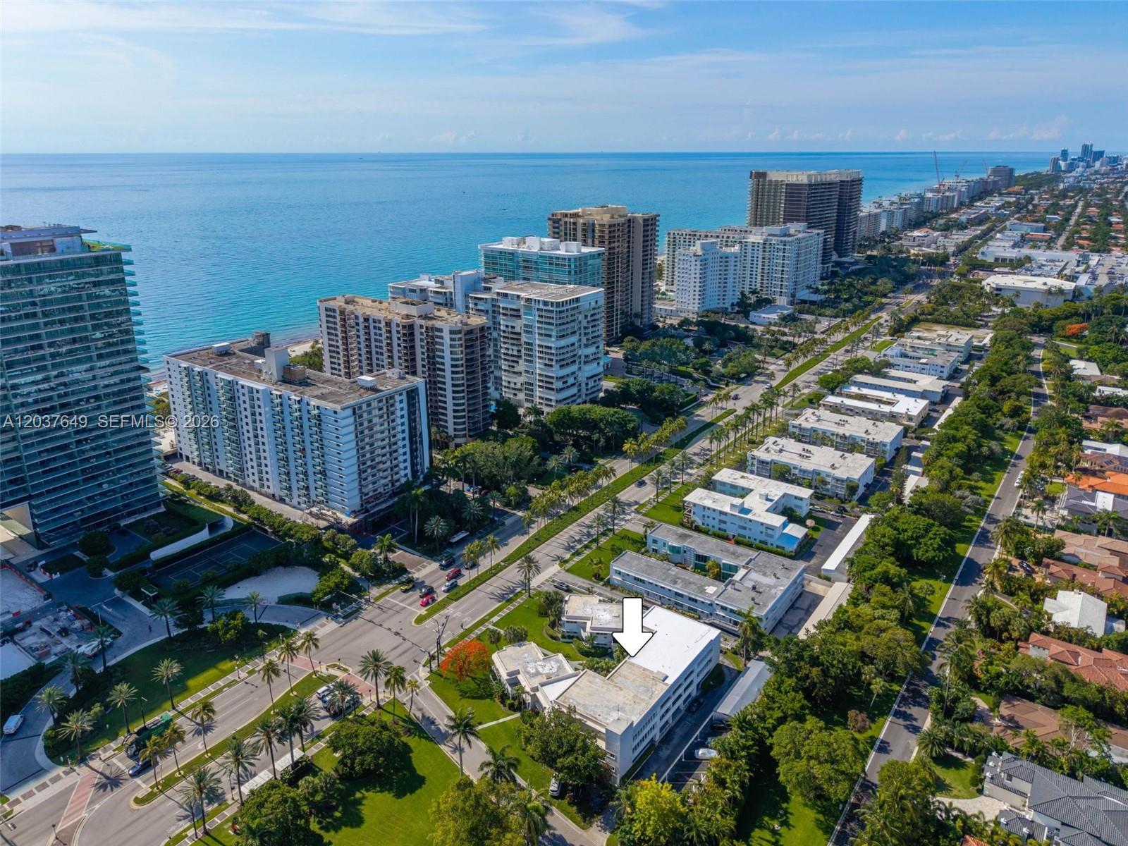 An aerial view shows a multi-story apartment building marked with an arrow near the coast — 10190 Collins Ave # 107, Bal Harbour FL 33154, BAL HARBOUR, FL