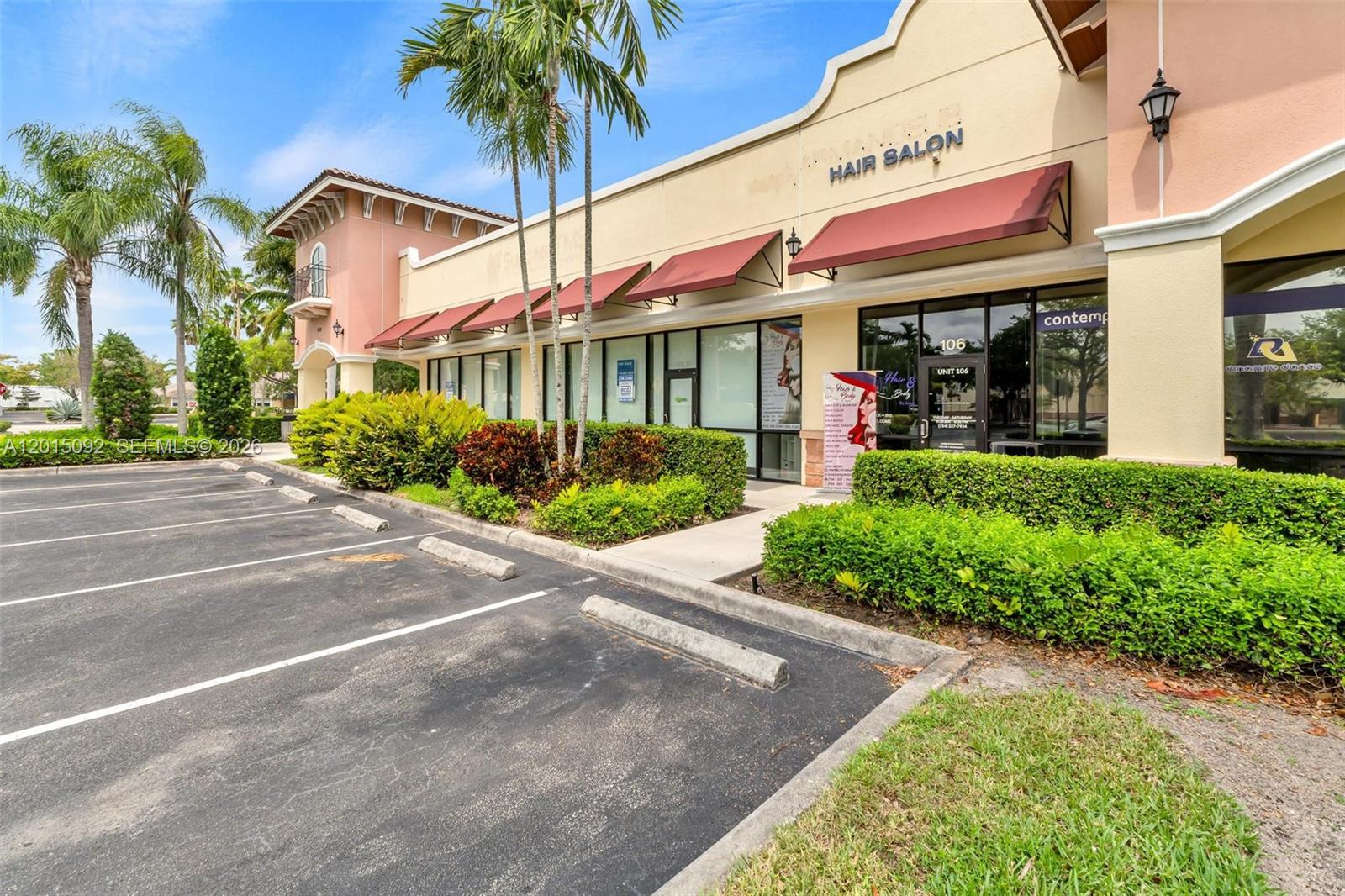 An exterior view of a commercial building with a hair salon and parking spaces — 6370 N State Road 7, Coconut Creek FL 33073, COCONUT CREEK, FL