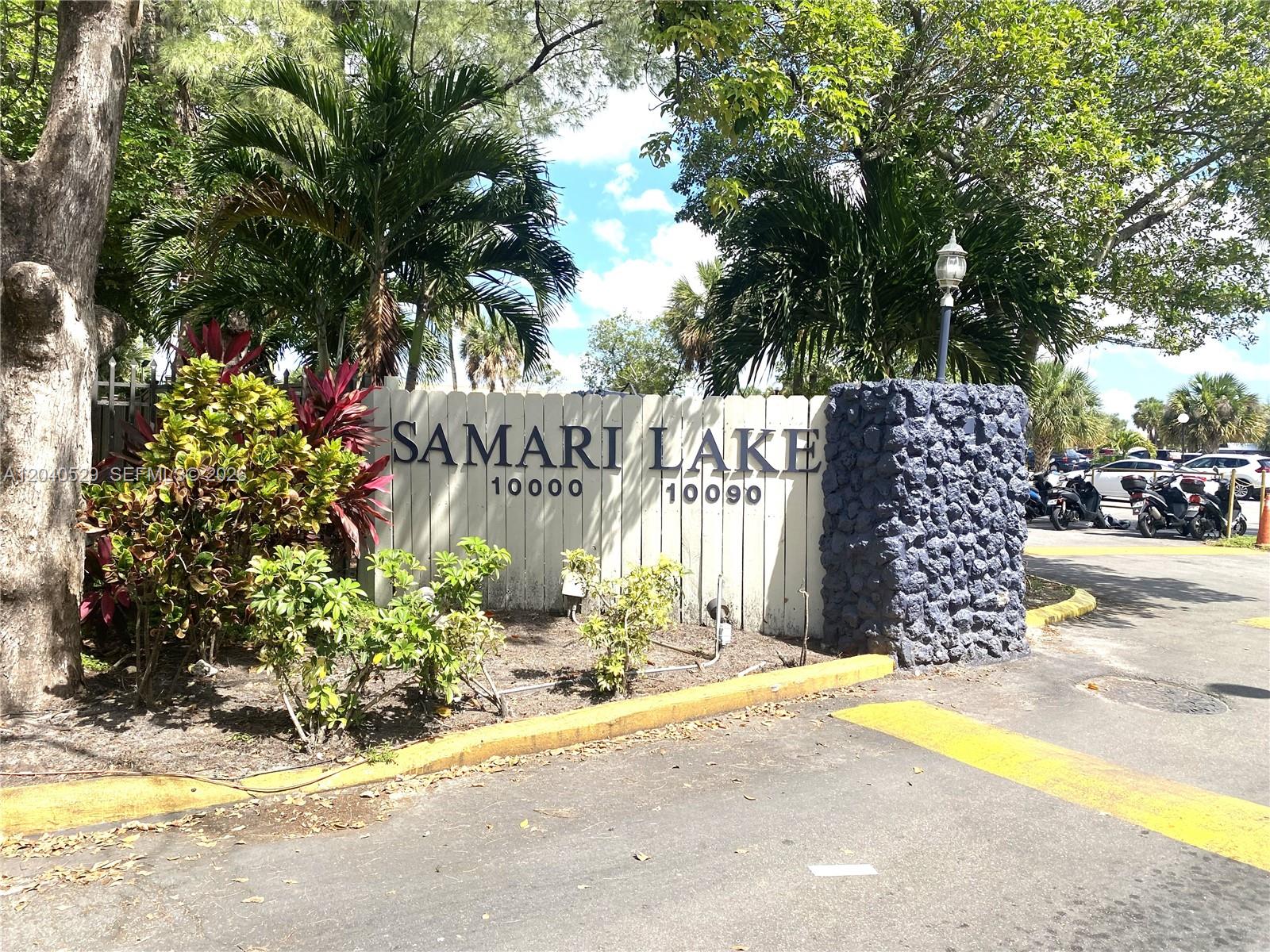 A sign for Samari Lake stands behind a stone pillar and lush tropical landscaping — 10000 NW 80 Ct # 2537, Hialeah Gardens FL 33016, HIALEAH GARDENS, FL