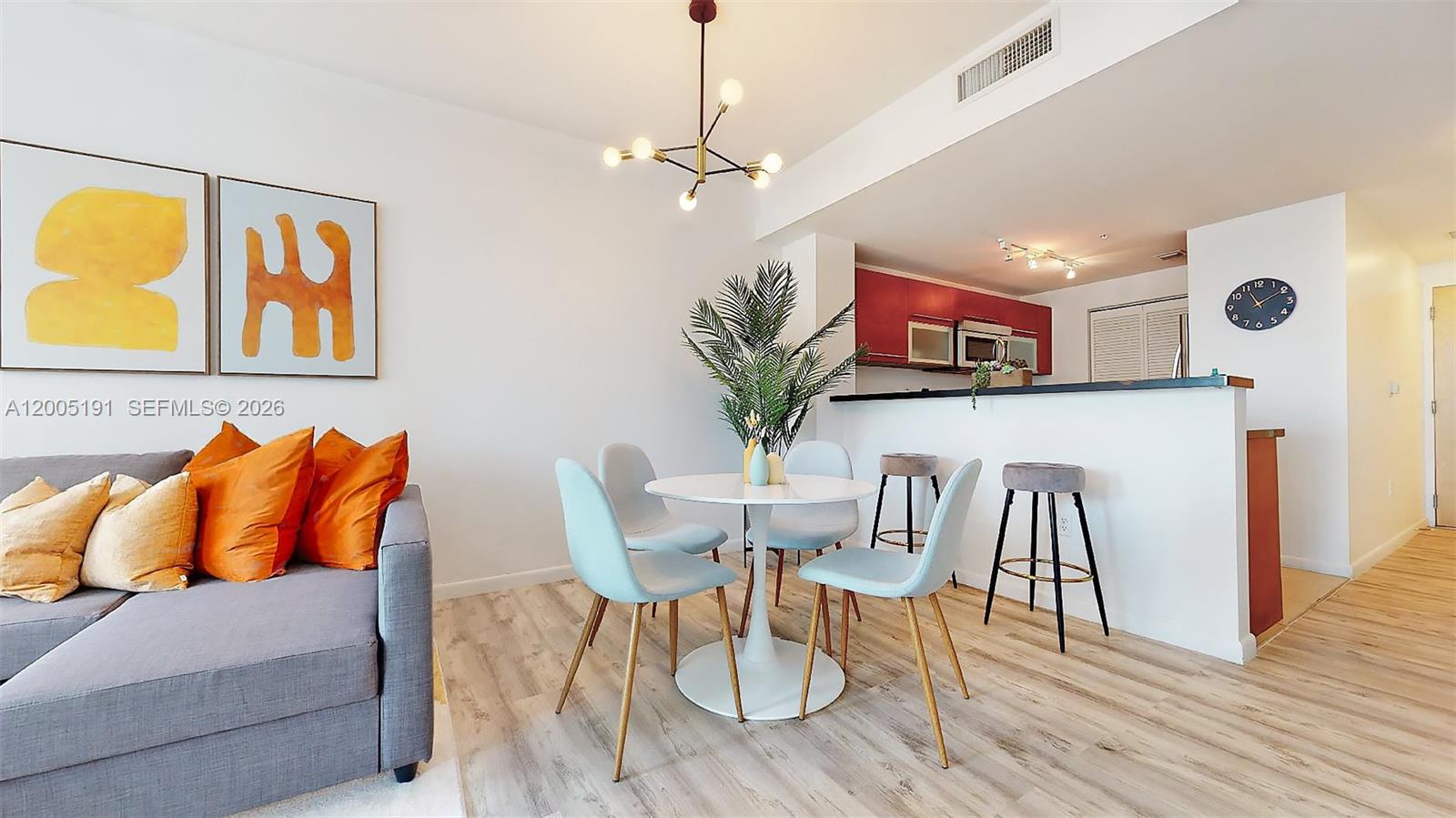 A dining area with a round table and chairs sits adjacent to a kitchen counter — 244 Biscayne Blvd # 704, Miami FL 33132, MIAMI, FL