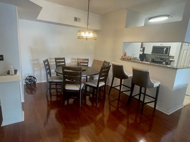 A dining area with a round table, chairs, and a breakfast bar with stools — 3408 Tuscany Way, Boynton Beach FL 33435, BOYNTON BEACH, FL