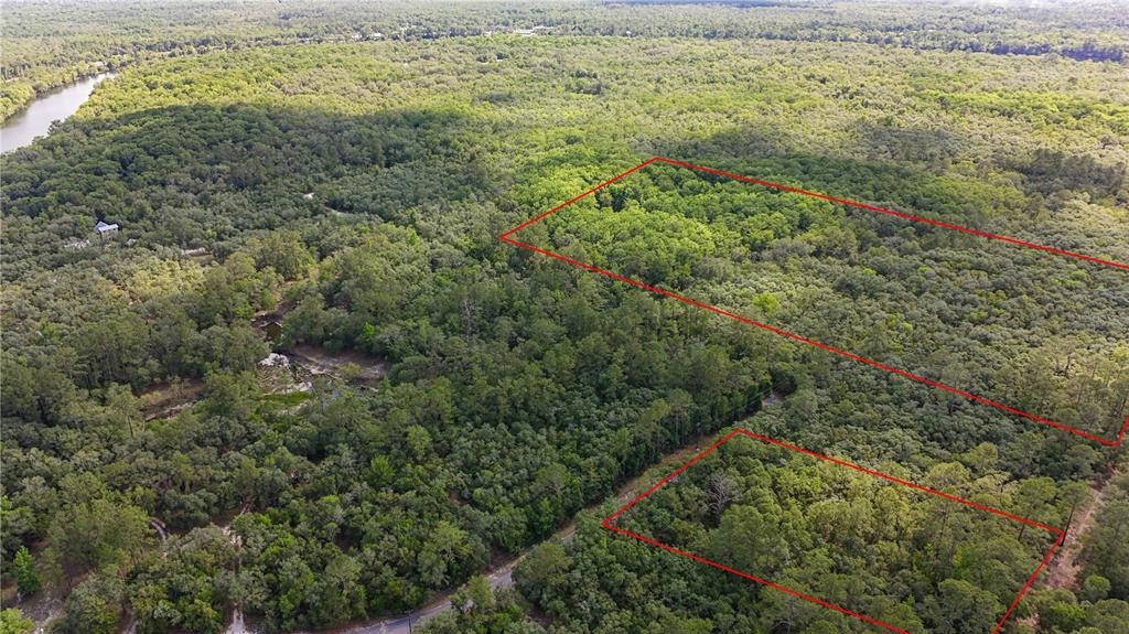 An aerial view shows two highlighted rectangular plots of land surrounded by dense forest — TBD OFF RIVERVIEW ROAD UNIT 9, FANNING SPRINGS, FL