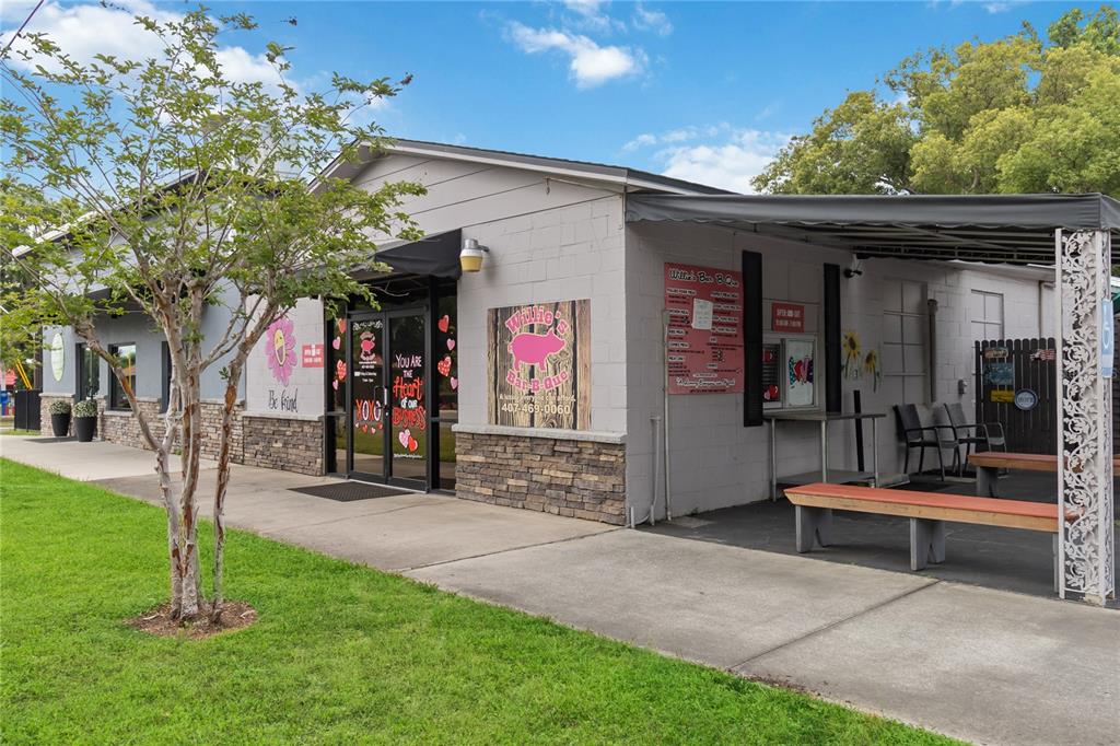 The exterior of a single-story commercial building features a covered patio and a grassy lawn — 17436 7TH STREET, MONTVERDE, FL