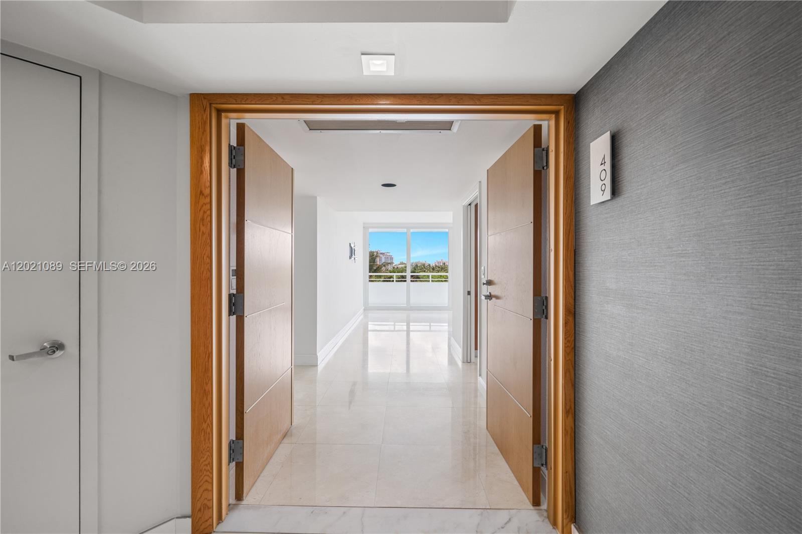 An open double-door entryway leads into a bright hallway with light tile flooring — 400 S Pointe Dr # 409, Miami Beach FL 33139, MIAMI BEACH, FL
