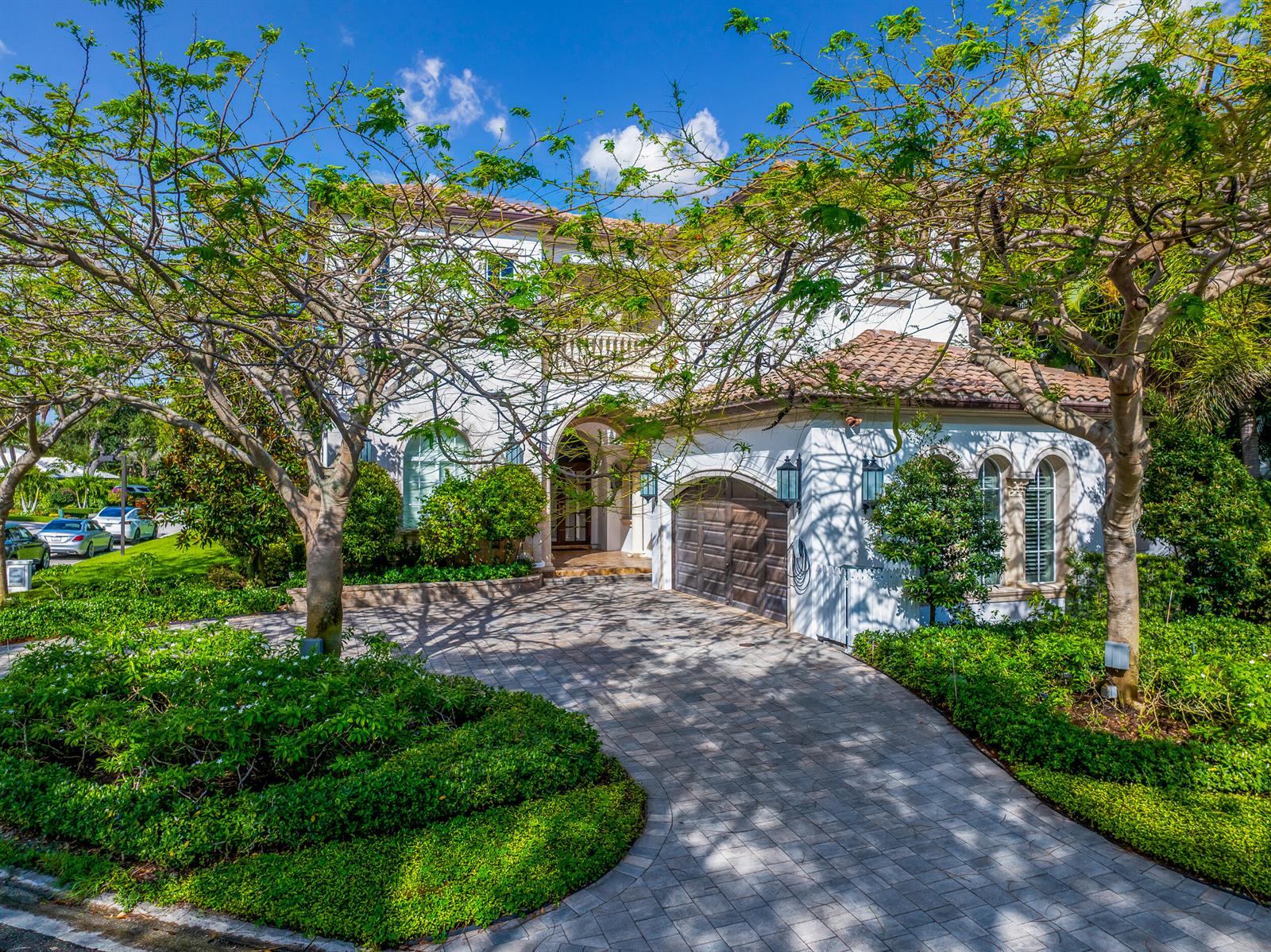 A two-story white stucco house with a tiled roof, arched entryway, and paved driveway — 629 Boca Marina Court, Boca Raton FL 33487, BOCA RATON, FL