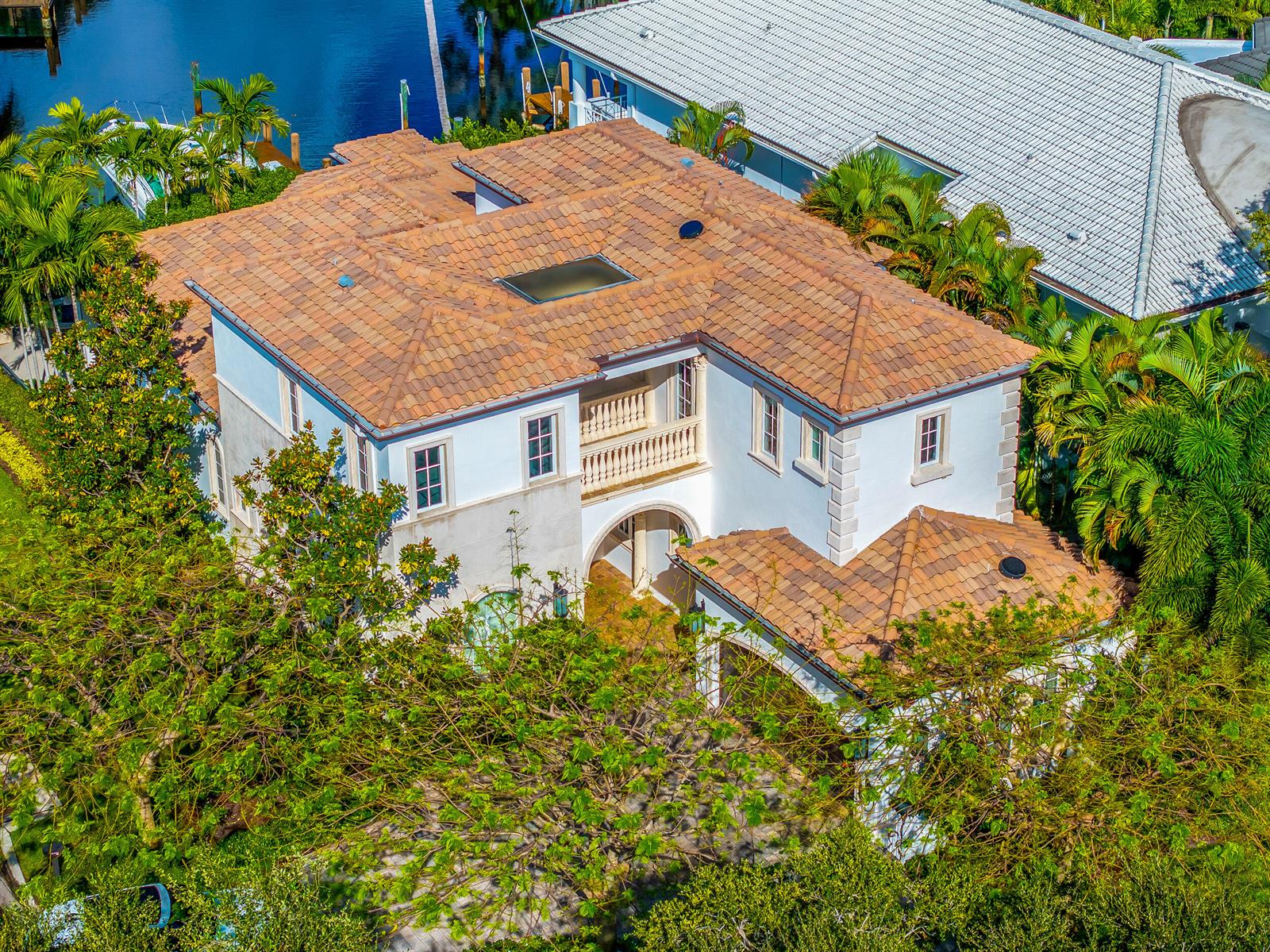 An aerial view of a two-story white house with a brown tile roof and balcony — 629 Boca Marina Court, Boca Raton FL 33487, BOCA RATON, FL
