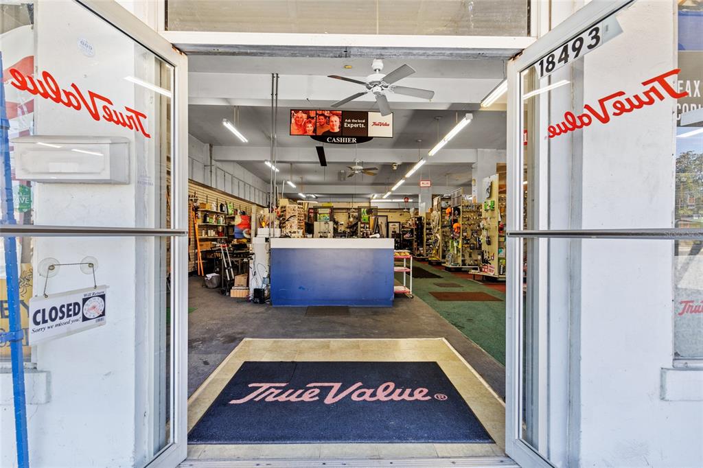 The entrance to a True Value hardware store shows a cashier counter and retail aisles — 18493 HIGH SPRINGS MAIN STREET, HIGH SPRINGS, FL