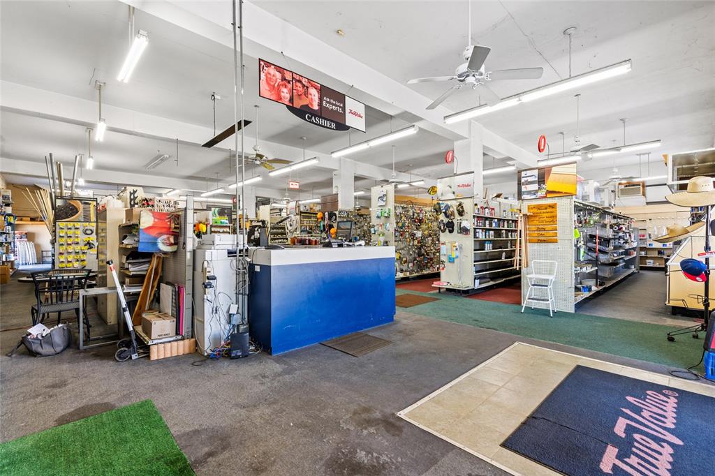This interior view shows a hardware store with a blue cashier counter and retail shelving — 18493 HIGH SPRINGS MAIN STREET, HIGH SPRINGS, FL