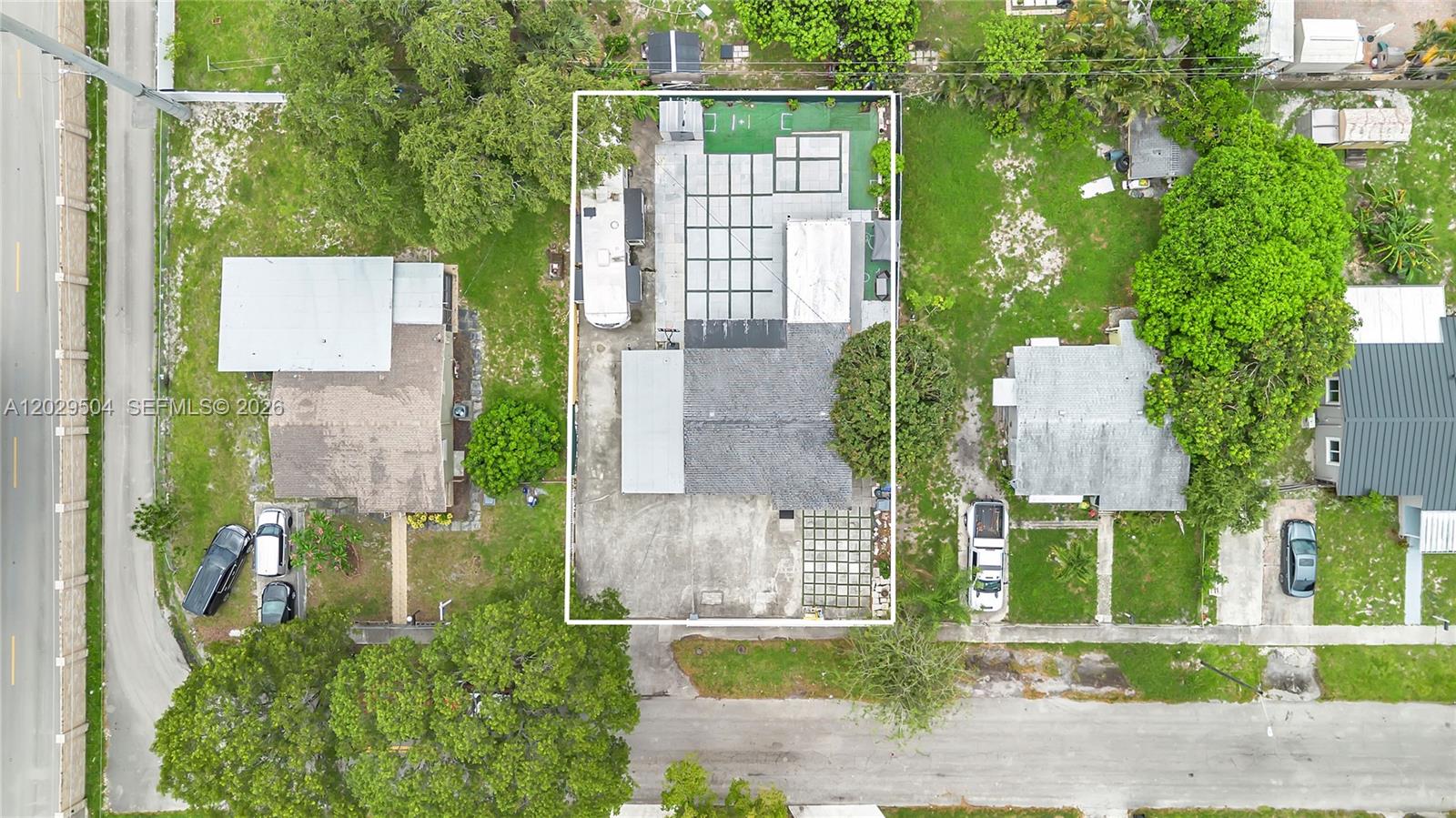 An aerial view shows a residential property with a house, paved driveway, and backyard patio — 6404 Meade St, Hollywood FL 33024, HOLLYWOOD, FL