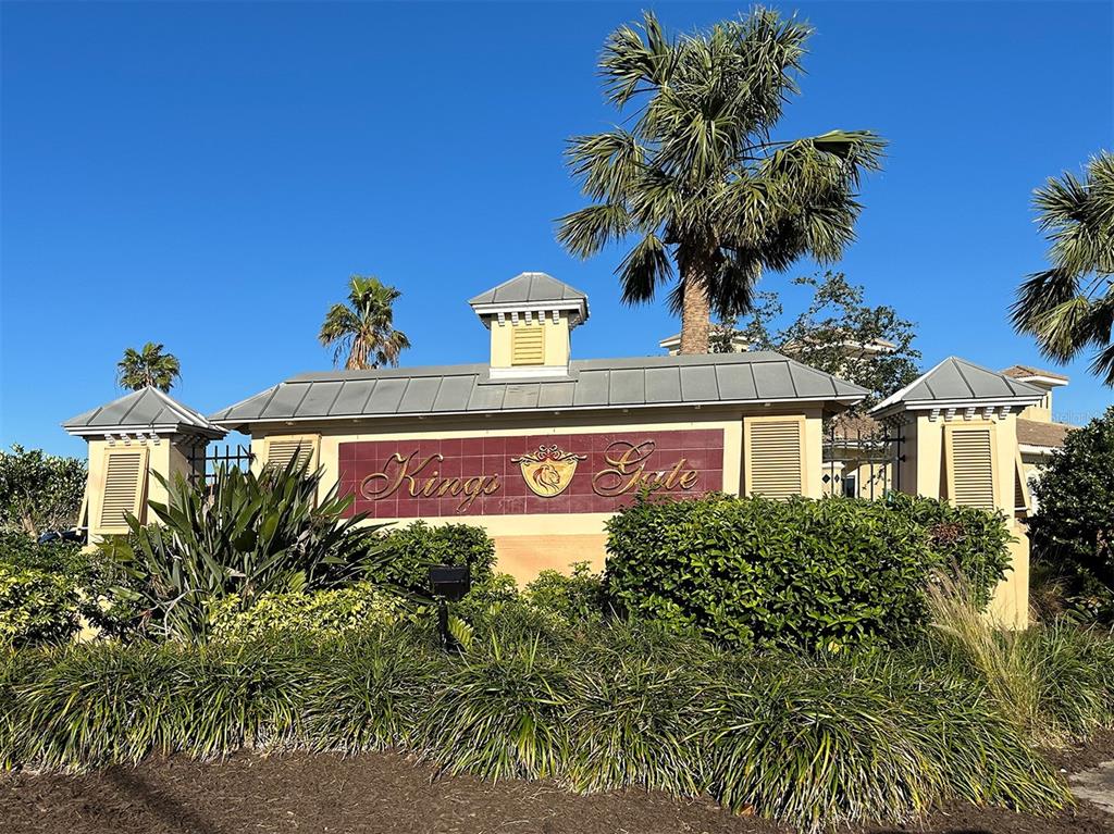 The exterior of a community entrance sign features the name Kings Gate with landscaping — 1799 NOTTINGHAM TRAIL, PUNTA GORDA, FL