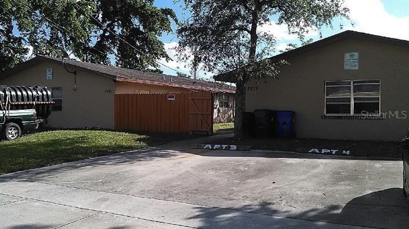 A view of two single-story apartment buildings with a shared concrete parking area in front — 2400 NW 21ST STREET UNIT 3, FORT LAUDERDALE, FL