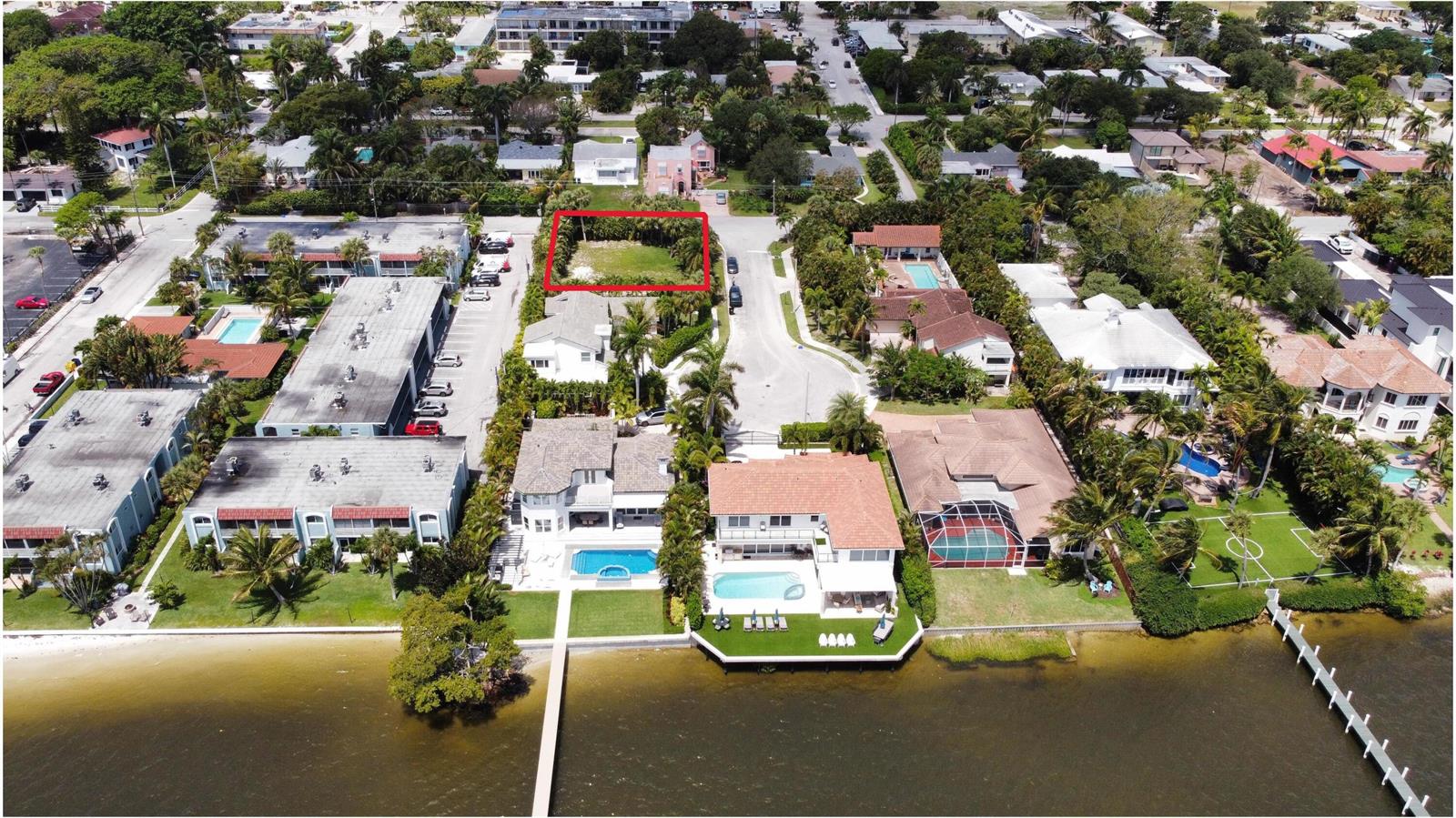 An aerial view shows a vacant rectangular lot outlined in red within a residential neighborhood — 7 Lakeside Palms Court, FL 33460, FL