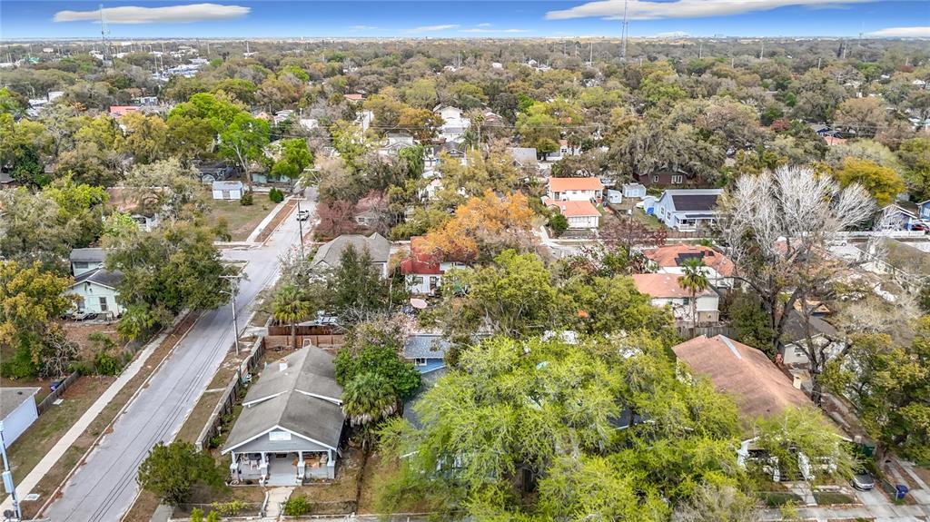 An aerial view shows a residential neighborhood with houses, trees, and streets — 1004 E 22ND AVENUE, TAMPA, FL