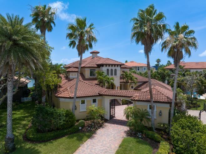 An exterior view of a two-story Mediterranean-style house with a tiled roof and palm trees — 841 PONCE DE LEON DRIVE, ST PETERSBURG, FL