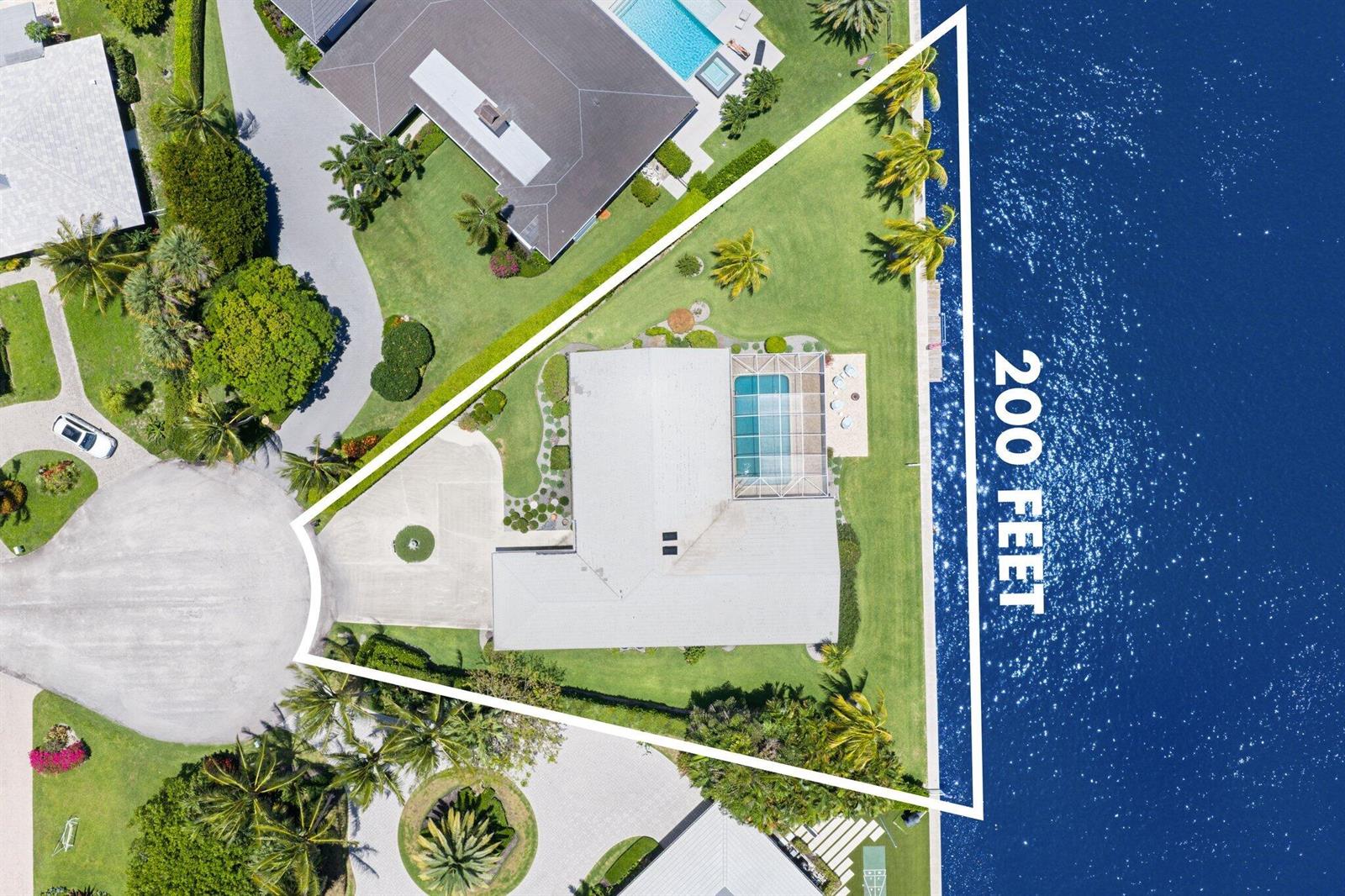 An aerial view shows a triangular waterfront property with a house, pool, and landscaping — 970 Orchid Lane, Gulf Stream FL 33483, GULF STREAM, FL