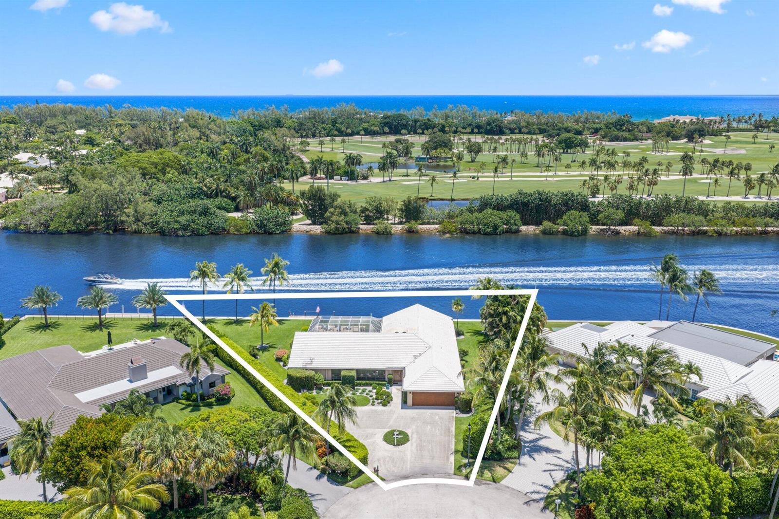 An aerial view shows a waterfront house with a white roof and a swimming pool — 970 Orchid Lane, Gulf Stream FL 33483, GULF STREAM, FL