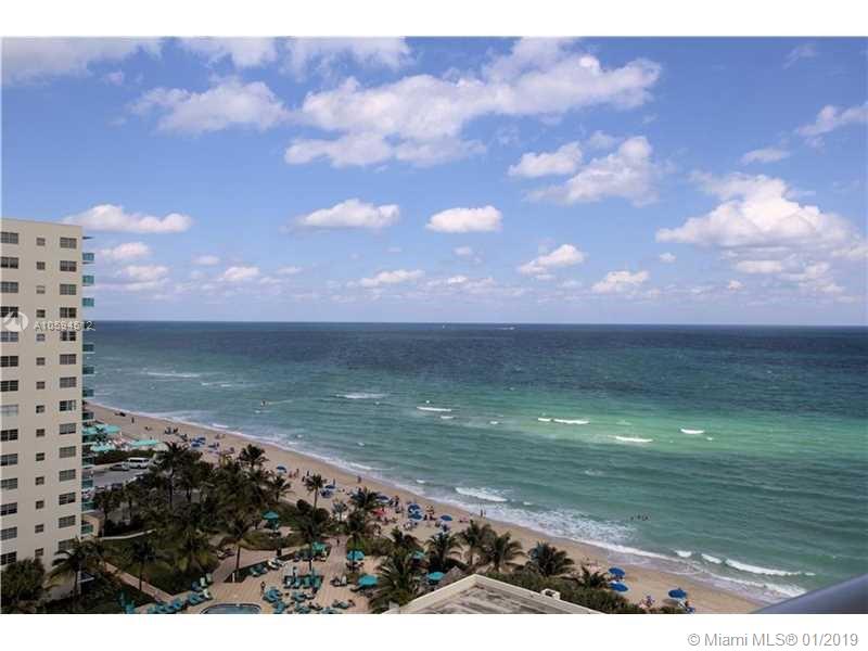 An elevated view of a sandy beach, ocean, and a tall residential building — 3901 S Ocean Dr # 12D, Hollywood FL 33019, HOLLYWOOD, FL