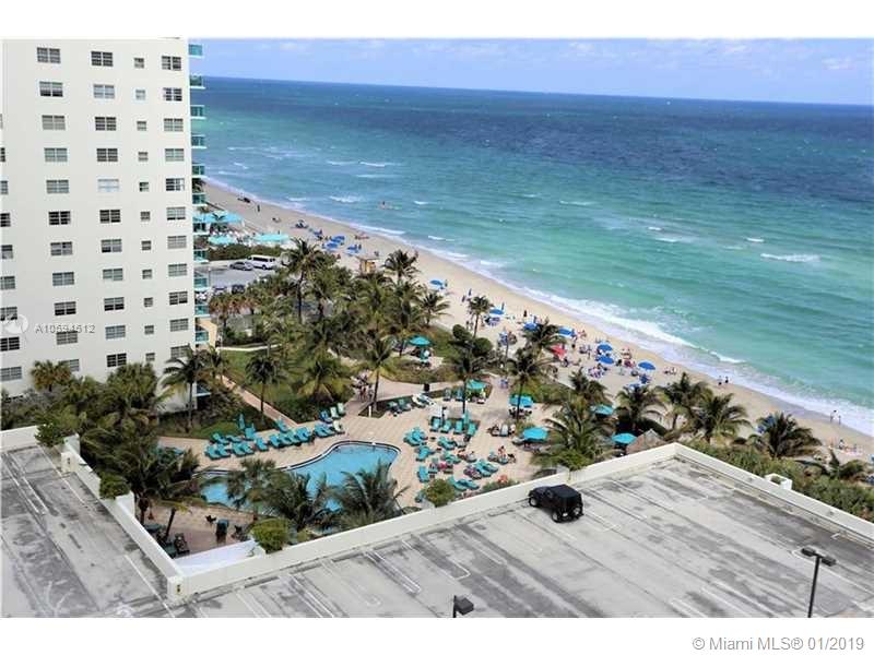 An elevated view of a beach resort featuring a swimming pool, palm trees, and oceanfront — 3901 S Ocean Dr # 12D, Hollywood FL 33019, HOLLYWOOD, FL
